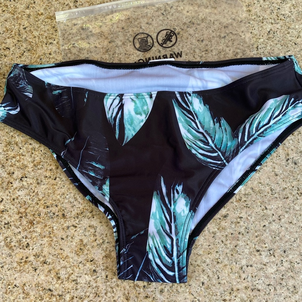 New in bag, bathing suit bottoms with leaf pattern